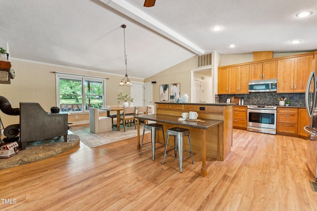 6971 Shady Creek Trl, Rougemont, NC 27572 - kitchen featuring appliances with stainless steel finishes, tasteful backsplash, light wood-type flooring, a kitchen breakfast bar, and dark countertops