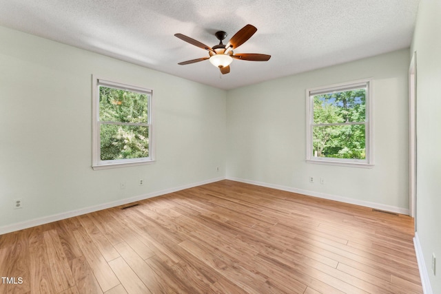 6971 Shady Creek Trl, Rougemont, NC 27572 - unfurnished room featuring light wood-type flooring, a ceiling fan, a textured ceiling, and baseboards