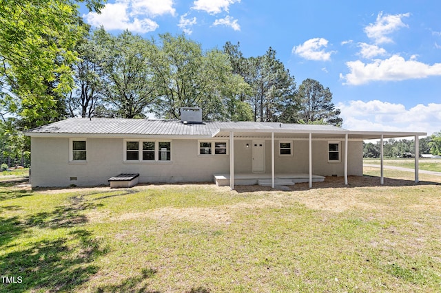 2003 Broadway Rd, Sanford, NC 27332 - rear view of house with a lawn, metal roof, a chimney, a patio, and a carport