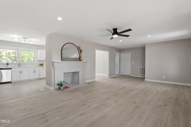 2003 Broadway Rd, Sanford, NC 27332 - unfurnished living room featuring ceiling fan, recessed lighting, light wood-style floors, and baseboards