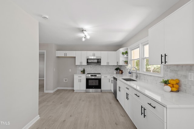 2003 Broadway Rd, Sanford, NC 27332 - kitchen featuring stainless steel appliances, a sink, backsplash, and open shelves
