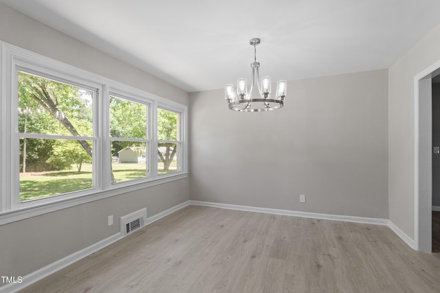 2003 Broadway Rd, Sanford, NC 27332 - empty room featuring a chandelier, light wood-style flooring, and baseboards