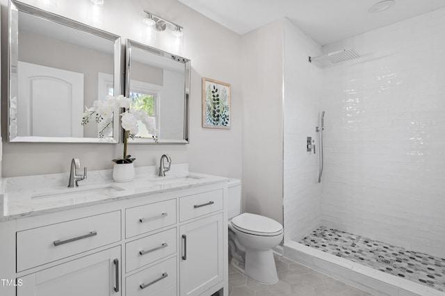2003 Broadway Rd, Sanford, NC 27332 - bathroom featuring double vanity, toilet, tiled shower, and tile patterned floors