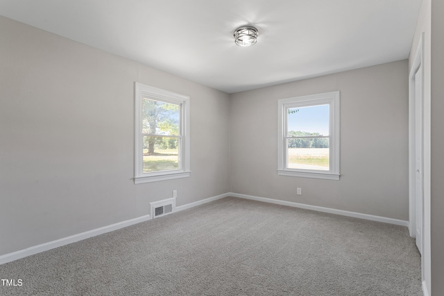 2003 Broadway Rd, Sanford, NC 27332 - spare room featuring healthy amount of natural light, carpet, and baseboards