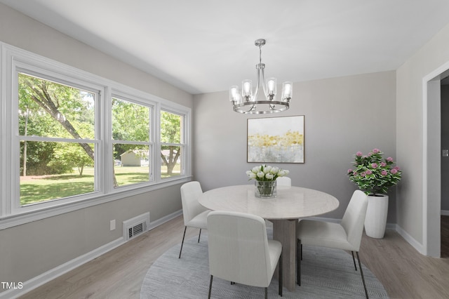 2003 Broadway Rd, Sanford, NC 27332 - dining room with a chandelier, light wood-type flooring, and baseboards