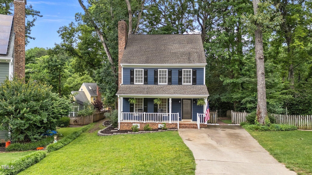 6717 Ebon Ct, Raleigh, NC 27615 - view of front of house with a porch, a chimney, driveway, and a shingled roof