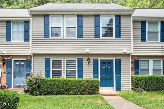 134 Luxon Pl, Cary, NC 27513 - townhome / multi-family property featuring brick siding and a front lawn