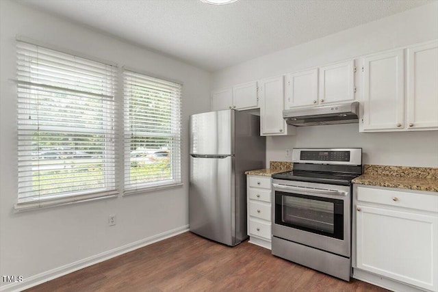 134 Luxon Pl, Cary, NC 27513 - kitchen featuring appliances with stainless steel finishes, under cabinet range hood, white cabinets, dark wood-style flooring, and light stone counters