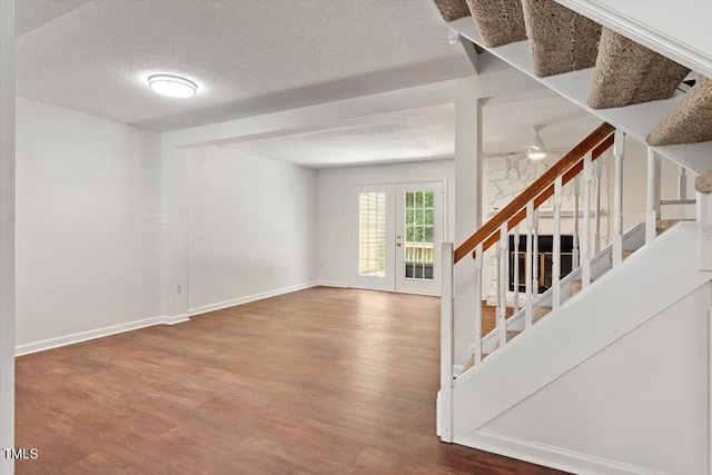 134 Luxon Pl, Cary, NC 27513 - unfurnished living room featuring stairway, wood finished floors, a textured ceiling, and ceiling fan