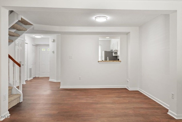 134 Luxon Pl, Cary, NC 27513 - empty room featuring stairs and dark wood-style flooring