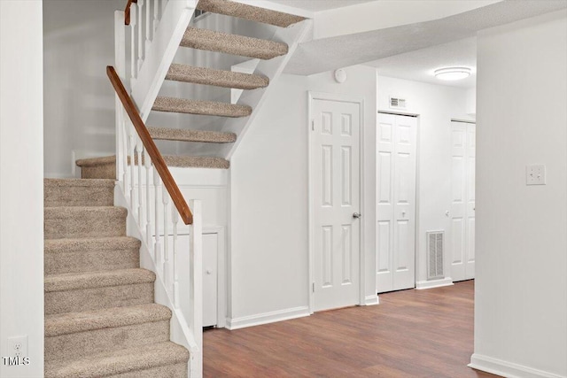 134 Luxon Pl, Cary, NC 27513 - stairs featuring wood finished floors