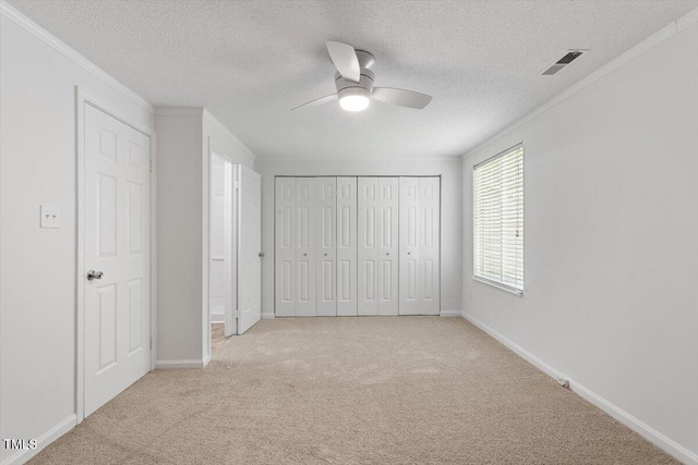 134 Luxon Pl, Cary, NC 27513 - unfurnished bedroom with carpet floors, crown molding, a textured ceiling, and a ceiling fan