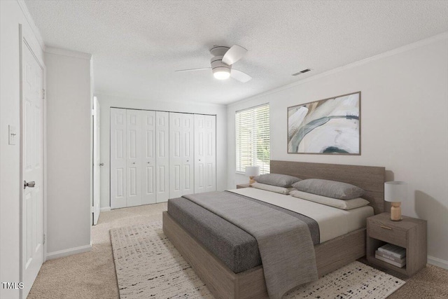 134 Luxon Pl, Cary, NC 27513 - bedroom with light colored carpet, a closet, ornamental molding, a textured ceiling, and ceiling fan