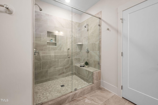 10310 Sablewood Dr Unit 111, Raleigh, NC 27617 - bathroom with a stall shower, baseboards, and marble finish flooring