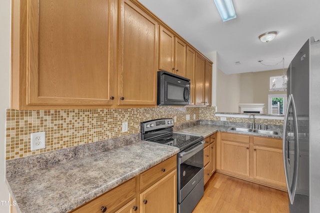 2513 Asher View Ct, Raleigh, NC 27606 - kitchen featuring appliances with stainless steel finishes, a sink, light wood-type flooring, and decorative backsplash