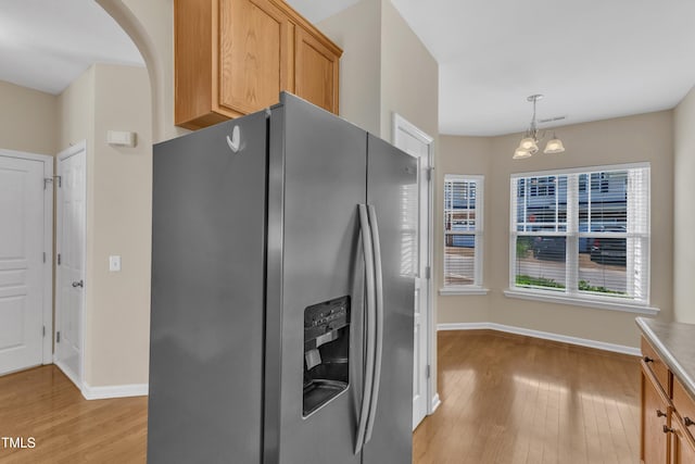 2513 Asher View Ct, Raleigh, NC 27606 - kitchen featuring stainless steel refrigerator with ice dispenser, light wood-style flooring, baseboards, and a chandelier