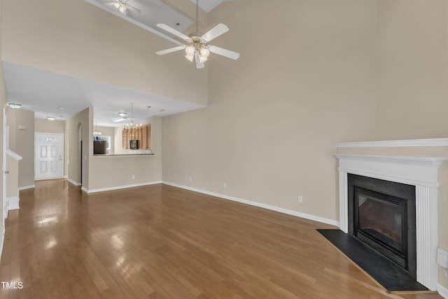 2513 Asher View Ct, Raleigh, NC 27606 - unfurnished living room with a ceiling fan, a fireplace with flush hearth, wood finished floors, and baseboards