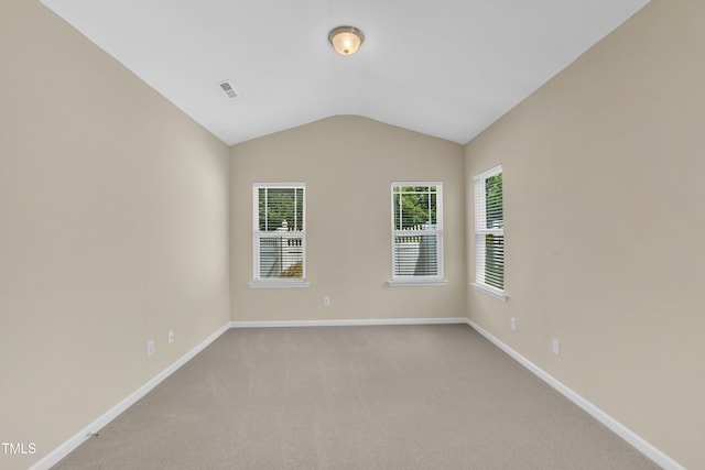 2513 Asher View Ct, Raleigh, NC 27606 - spare room featuring vaulted ceiling, baseboards, and light carpet