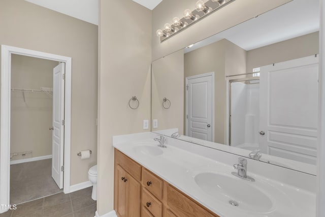 2513 Asher View Ct, Raleigh, NC 27606 - bathroom with double vanity, toilet, a walk in closet, a shower with shower door, and tile patterned floors