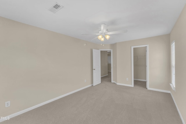 2513 Asher View Ct, Raleigh, NC 27606 - unfurnished bedroom featuring a spacious closet, baseboards, light carpet, a closet, and ceiling fan