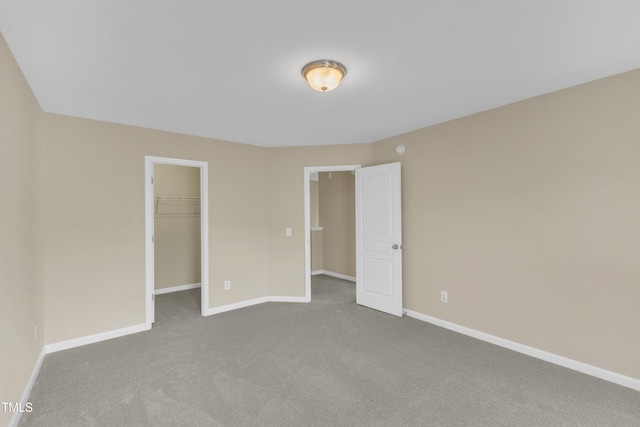 2513 Asher View Ct, Raleigh, NC 27606 - unfurnished bedroom featuring carpet, baseboards, a walk in closet, and a closet