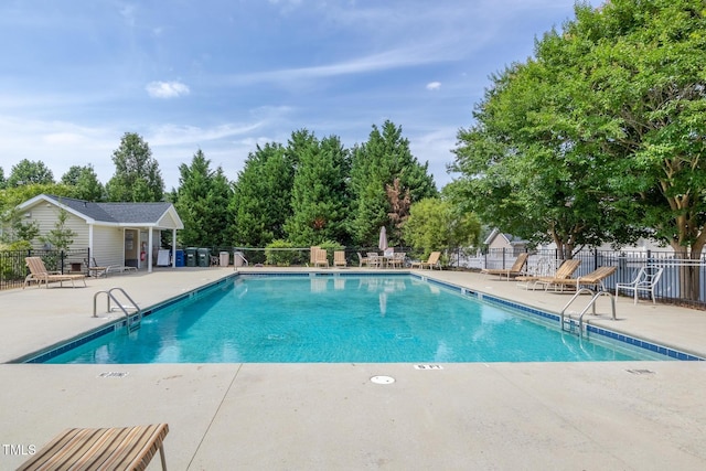2513 Asher View Ct, Raleigh, NC 27606 - community pool featuring a patio area and view of wooded area