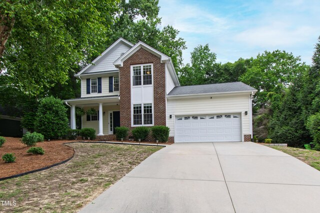 3821 La Costa Way, Raleigh, NC 27610 - traditional home with concrete driveway, a garage, and a porch