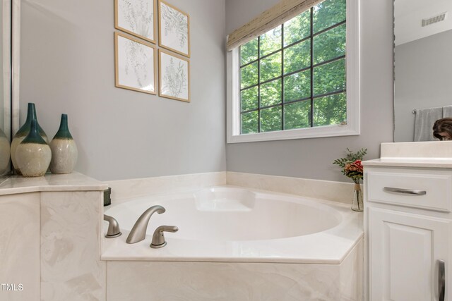 3821 La Costa Way, Raleigh, NC 27610 - bathroom featuring a garden tub and vanity