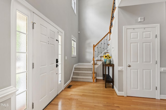 3821 La Costa Way, Raleigh, NC 27610 - entryway with stairway, light wood-type flooring, and baseboards