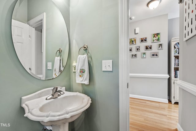 3821 La Costa Way, Raleigh, NC 27610 - bathroom with wood finished floors, a sink, and baseboards
