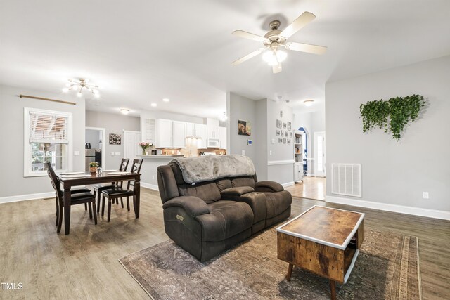 3821 La Costa Way, Raleigh, NC 27610 - living area with light wood-style flooring, ceiling fan, and baseboards
