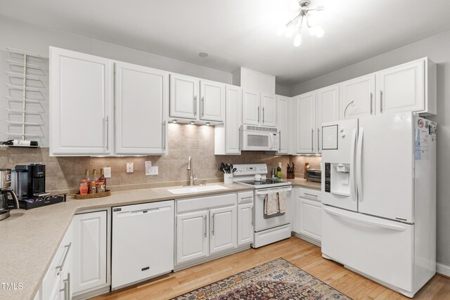 3821 La Costa Way, Raleigh, NC 27610 - kitchen featuring white appliances, a sink, white cabinetry, and light wood finished floors