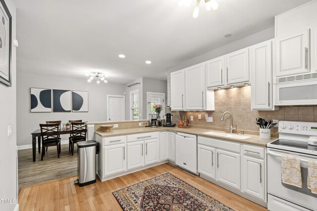 3821 La Costa Way, Raleigh, NC 27610 - kitchen featuring white appliances, a sink, light countertops, tasteful backsplash, and white cabinets