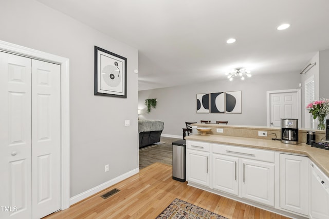 3821 La Costa Way, Raleigh, NC 27610 - kitchen featuring white cabinets, light wood finished floors, baseboards, light countertops, and recessed lighting