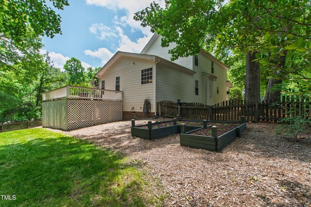 3821 La Costa Way, Raleigh, NC 27610 - rear view of house with a garden and a wooden deck