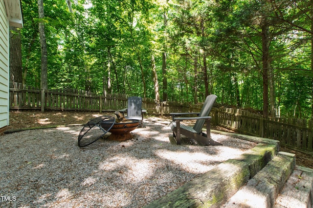 3821 La Costa Way, Raleigh, NC 27610 - fenced backyard with a fire pit and a forest view