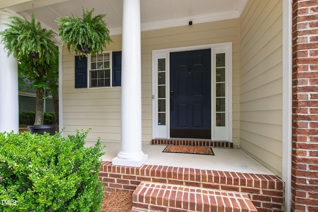 3821 La Costa Way, Raleigh, NC 27610 - doorway to property featuring covered porch and brick siding