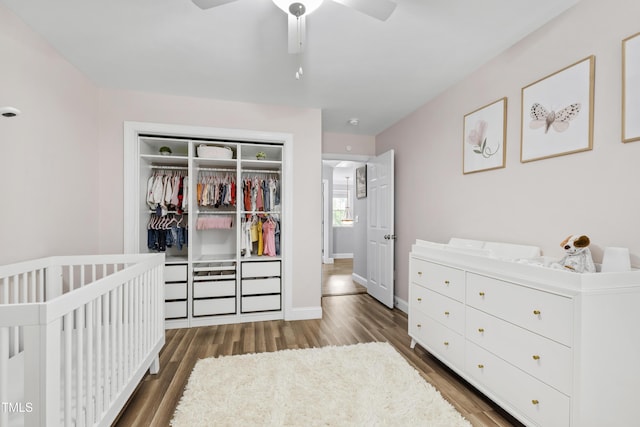 3821 La Costa Way, Raleigh, NC 27610 - bedroom featuring a closet, wood finished floors, baseboards, a crib, and a ceiling fan