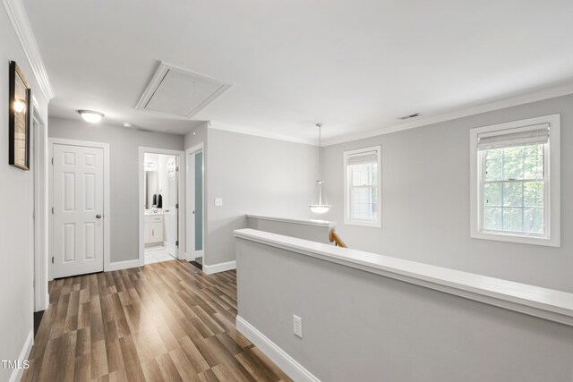 3821 La Costa Way, Raleigh, NC 27610 - hall featuring attic access, baseboards, dark wood-type flooring, crown molding, and an upstairs landing