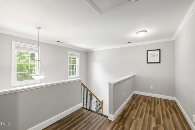 3821 La Costa Way, Raleigh, NC 27610 - empty room with attic access, baseboards, wood finished floors, and crown molding