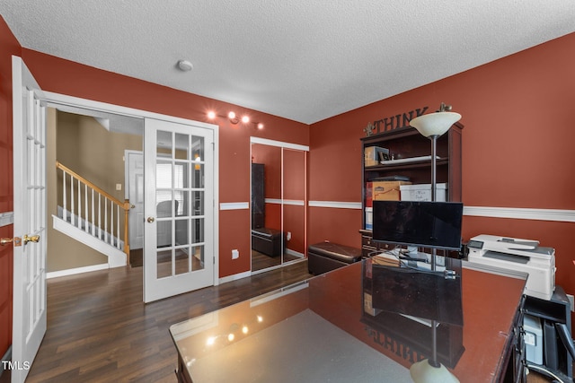 office area with french doors, wood finished floors, a textured ceiling, and baseboards