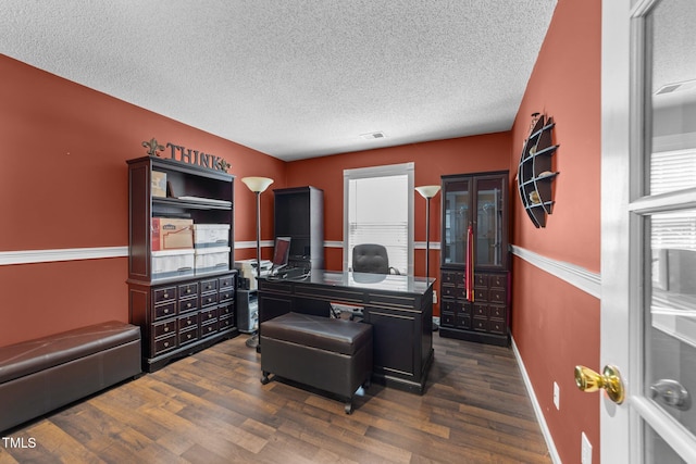 office featuring a textured ceiling, dark wood-style floors, and baseboards