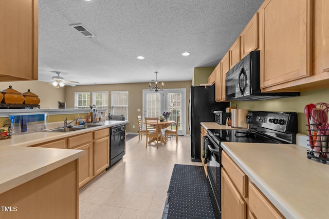 kitchen featuring black appliances, a sink, light countertops, a textured ceiling, and recessed lighting