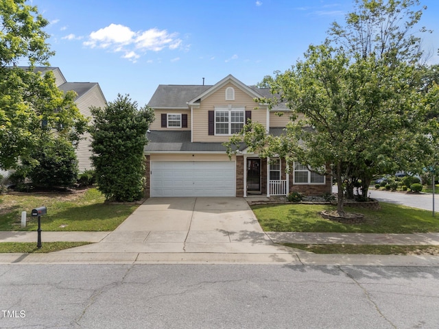 view of front facade with driveway, a garage, and a front lawn