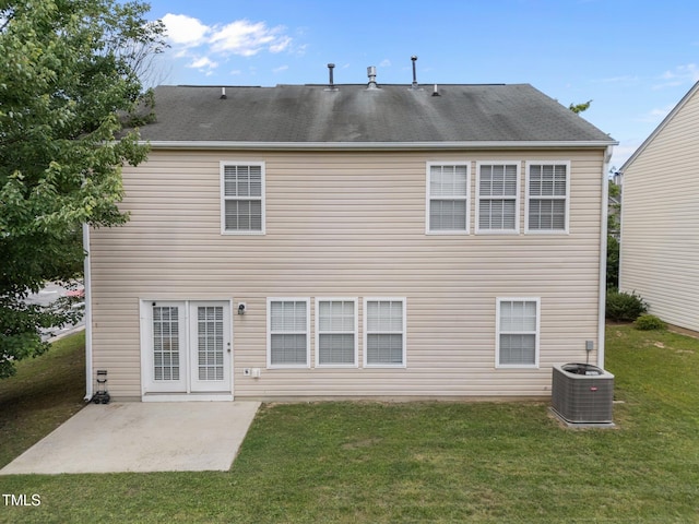 rear view of house with a patio area, a lawn, and central AC unit