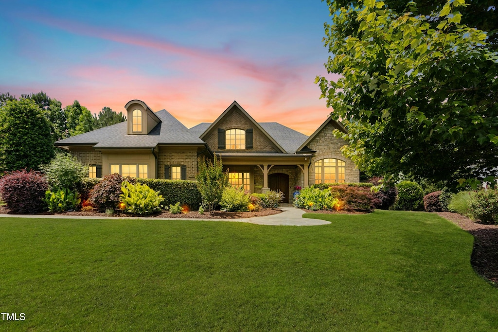 238 Michelangelo Way, Cary, NC 27518 - view of front of property featuring brick siding, a yard, and stone siding