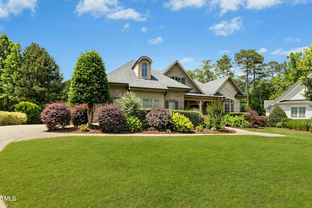 238 Michelangelo Way, Cary, NC 27518 - view of front of house featuring a front yard, brick siding, and a shingled roof