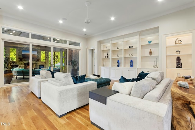 238 Michelangelo Way, Cary, NC 27518 - living area featuring crown molding, a stone fireplace, light wood-style floors, recessed lighting, and built in features