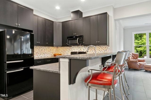 238 Michelangelo Way, Cary, NC 27518 - kitchen with black appliances, tile patterned flooring, a breakfast bar area, decorative backsplash, and crown molding