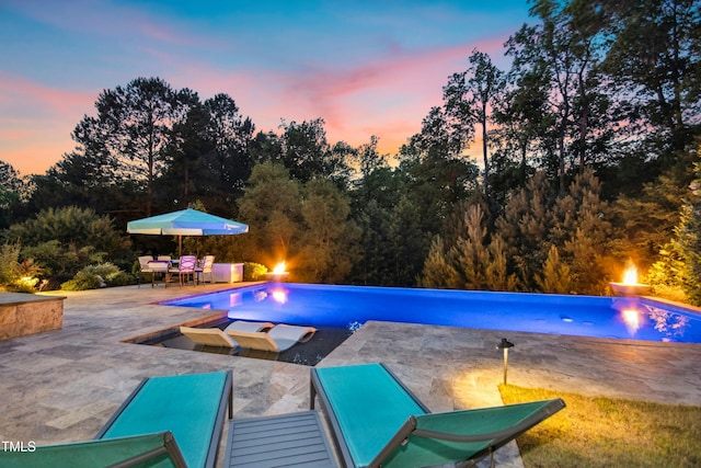 238 Michelangelo Way, Cary, NC 27518 - pool at dusk featuring a patio area, an outdoor pool, and view of scattered trees